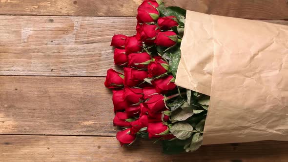 red roses bouquet on old wood floor