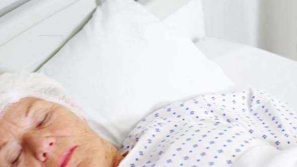 Senior woman patient sleeping on bed