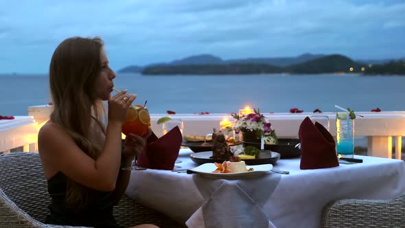 Woman in Sexy Evening Dress Sip Cocktail Via Straw in Luxury Hotel Restaurant