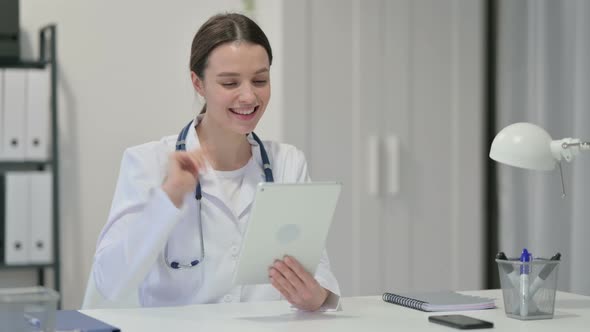 Female Doctor Talking on Video Chat on Tablet 