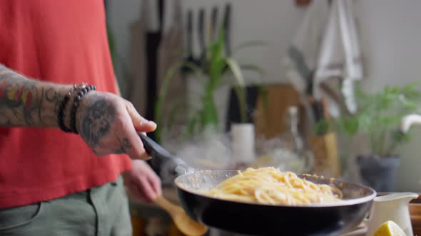 Tossing Pasta in Skillet while Frying