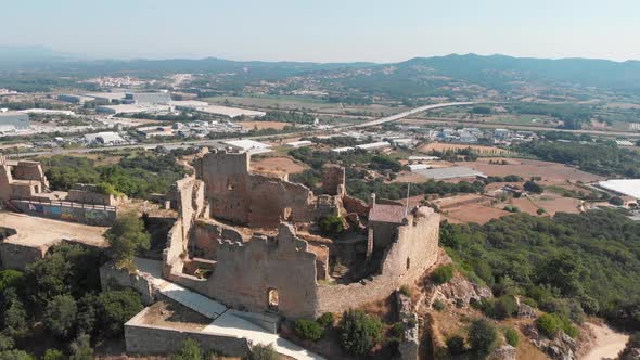 falling aerial of Castell de Palafolls near Barcelona, Spain. Cataluña offers a cultural experience