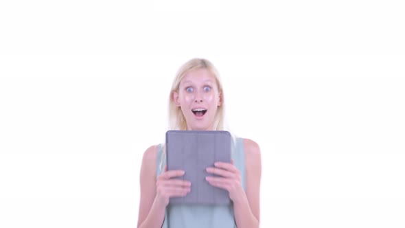 Face of Happy Young Blonde Woman Using Digital Tablet and Looking Surprised