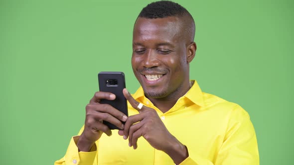 Young Happy African Businessman Using Phone