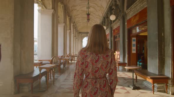 Back View of Traveling Woman Walking in Historic Street in Venice Italy Europe