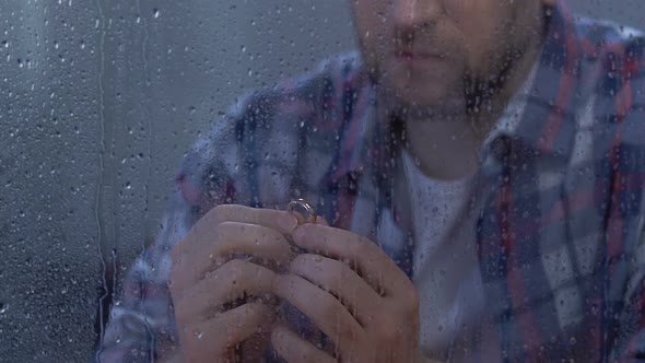 Depressed Male Holding Engagement Ring, Rejected Proposal or Divorce, Crisis