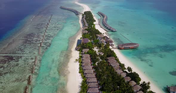 Tropical fly over clean view of a sunshine white sandy paradise beach and blue water background in c