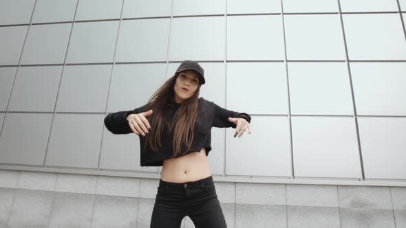 Woman Dancing and Performs Modern Hip-hop Dance Against Metal Wall, Freestyle in the Street, Urban