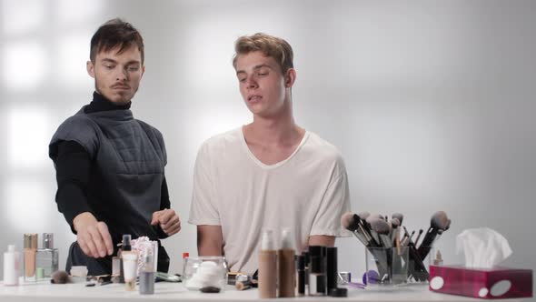 Young Man Having Professional Makeup in Studio