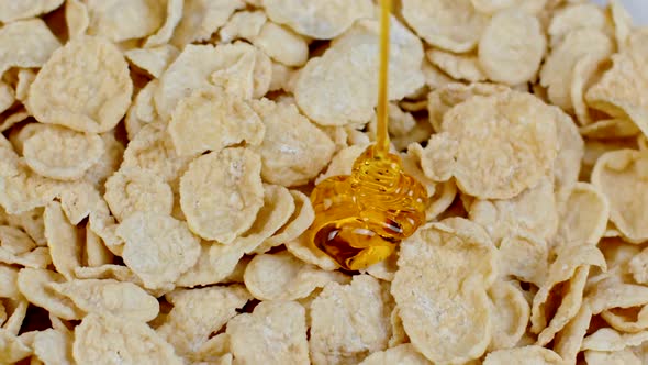 Close-up Honey Golden Fruity Caramel Sauce Pouring Into Corn Flakes, Slow Motion