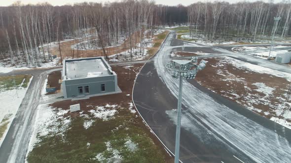 Building and Large Concrete Pool at Snowy Construction Site