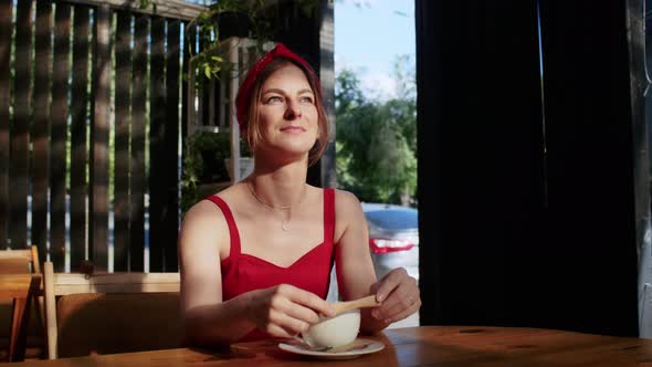 Happy Girl in a Cafe Drinks Coffee Enjoyment in the Summer and Lifestyle