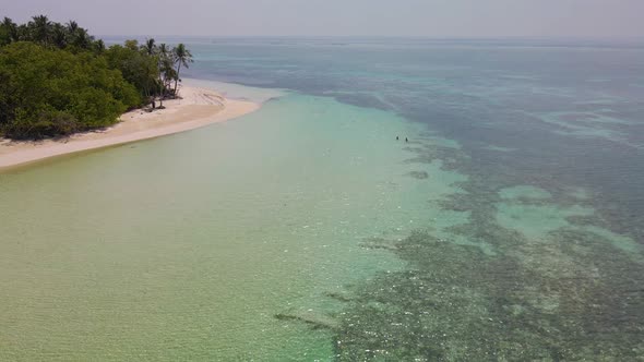 Beautiful panorama of the Maldivian island with a sandy shore and turquoise water