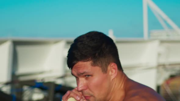 Young Strong Man with Naked Torso Exercising Box Outdoors Crew Boxing Workout Onboard Cruise Ship