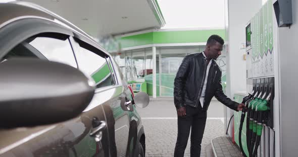 African American Stylish Man Refueling Car At Gas Station