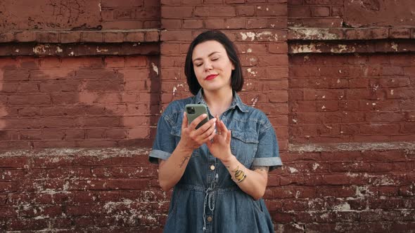 Amazed lucky woman using phone looks and sees the message with a good news 