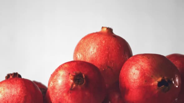 Super Slow Motion Whole Pomegranates Rise Up