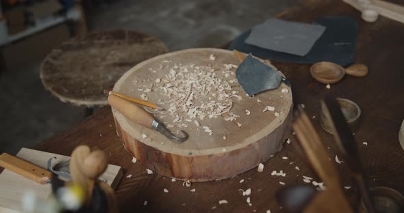 Woodworker's Workplace: Workbench, Carving Tools, Sandpaper and Wood Shavings