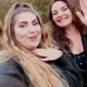 Three young women smiling and waving to camera in park, Italy - VideoHive Item for Sale