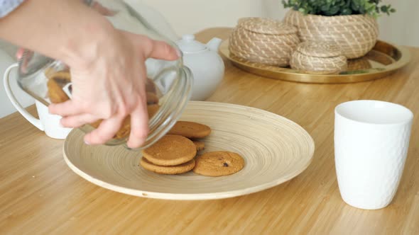 Woman Serves Breakfast with Biscuits on Table in Kitchen