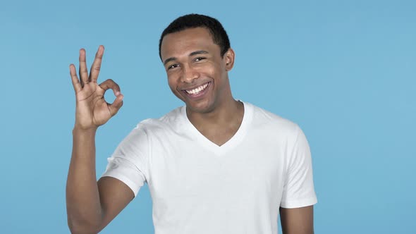 Okay Sign By African Man, Blue Background
