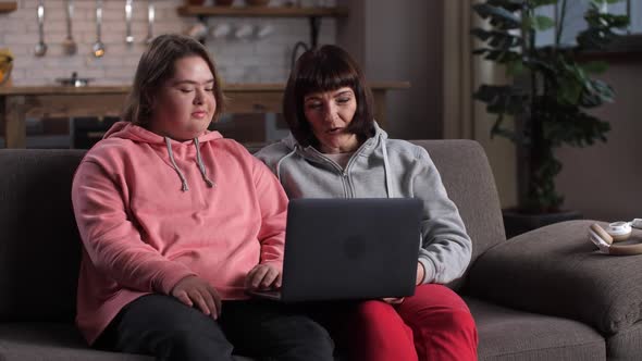 Kid with Down Syndrome and Her Mom Chatting Online