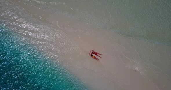 Young couple in love dating on vacation enjoy luxury on beach on white sand background 4K