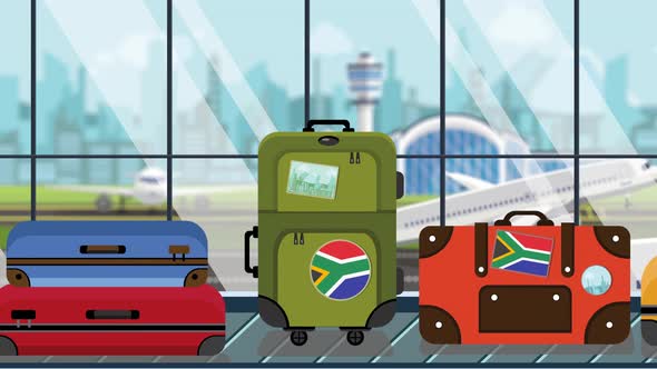 Suitcases with Flag of South Africa Stickers on Baggage