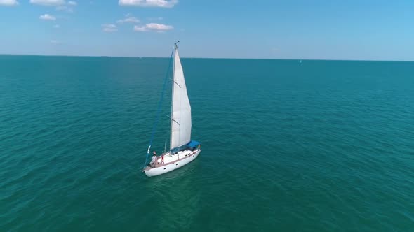 Seascape with sail boat. Aerial view of lonely ship sailing in the open sea