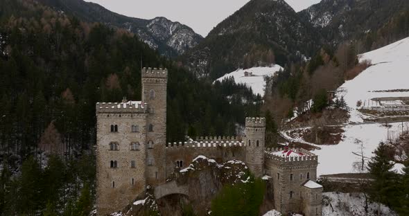 Splendid fly view of Gernestein Castle located in the Dolomites during winter time.