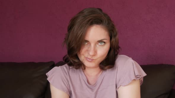 Closeup Portrait of a Young Beautiful Woman with Green Eyes and Dark Hair Who Looks Directly Into