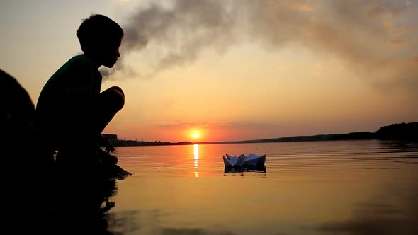 Boy Launching Paper Boat