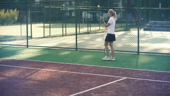 Female Tennis Player Exercising Set Ready To Serve Ball. Girl With Rocket Playing On Tennis Court.