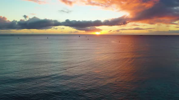 Aerial Drone Reveal of Picturesque Hawaiin Ocean Sunrise Over Waikiki Beach In Honolulu. Waves Rolli