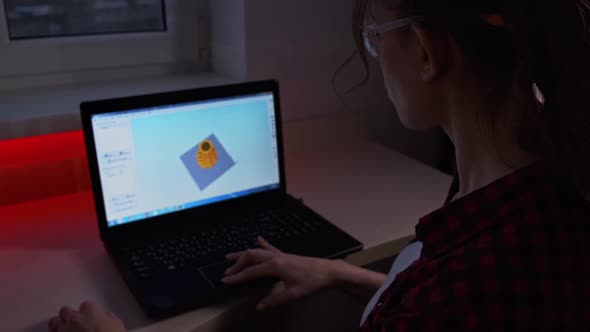 Creative Female Designer Pushing Button on Control Panel of 3d Printer to Start It While Sitting in