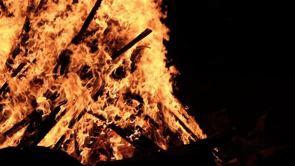 Big Bonfire Burns at Night in Slow Motion on a Black Background