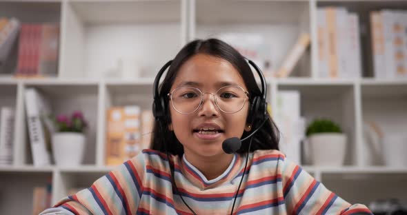 Girl headphone talking via laptop