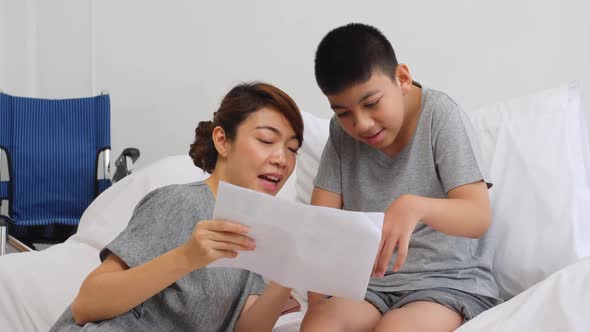 Happy family with mother and disabled son spending time together at home.