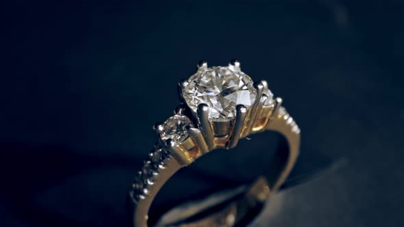 Extreme detailed of diamond ring close up shot while rotating on dark background