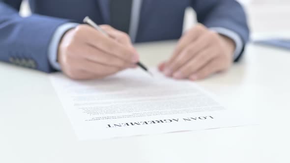 Businessman Reading Loan Agreement