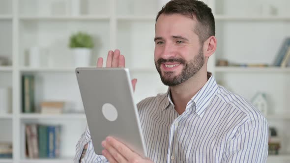 Portrait of Young Man Doing Video Chat on Tablet