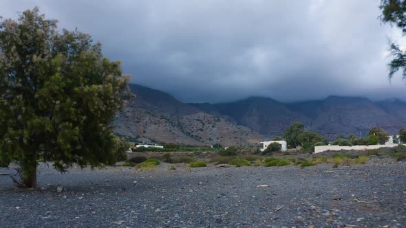 Aerial view of Greek Landscape. Clouds cover Mountain. Drone Flying near trees.