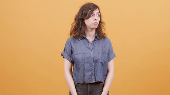 Young Woman Over Yellow Background Showing Signs of Approval