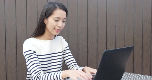 Woman Using Notebook Computer at Outdoor