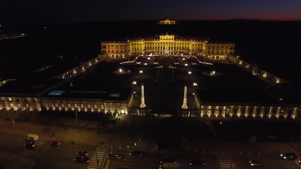 Aerial of a street in front of Schonbrunn at dusk
