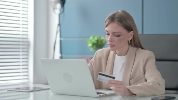 Businesswoman Shopping Online on Laptop at Work