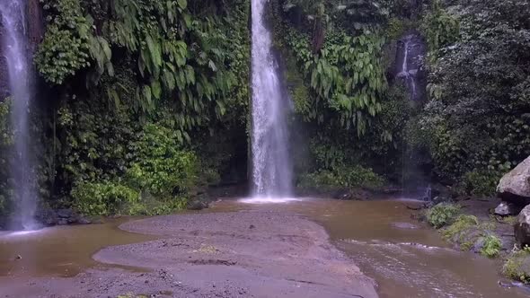 Waterfall way of life, Untouched jungle.Buttery soft aerial view flight pull in drone footage Benan