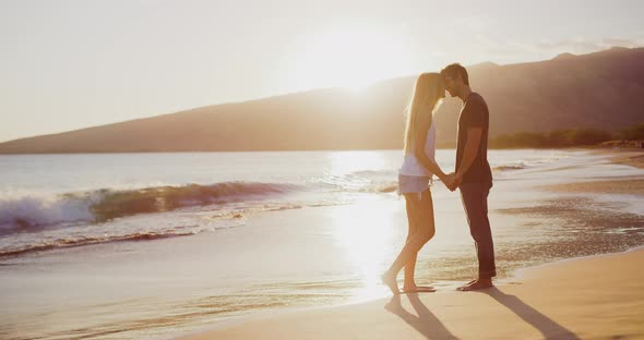 Attractive couple kissing on the beach