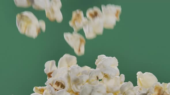 Fresh Popcorn Falls on Top of a Pile Isolated on ChromaKey Background