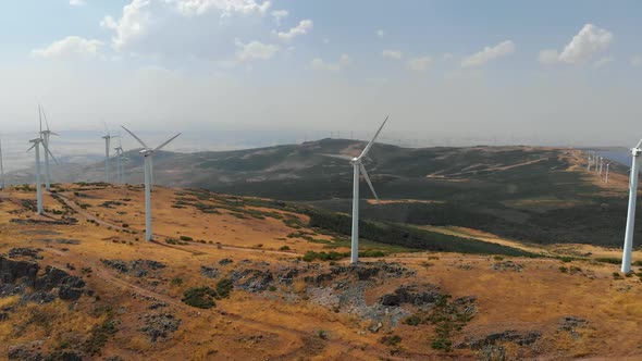 Aerial Panoramic View of a Windpower Plant Rotating Airscrews in Spain. Scenery with Hills and